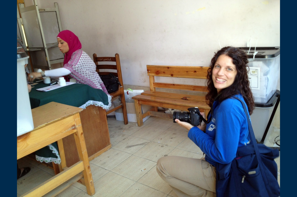 Woman in blue shirt taking photo